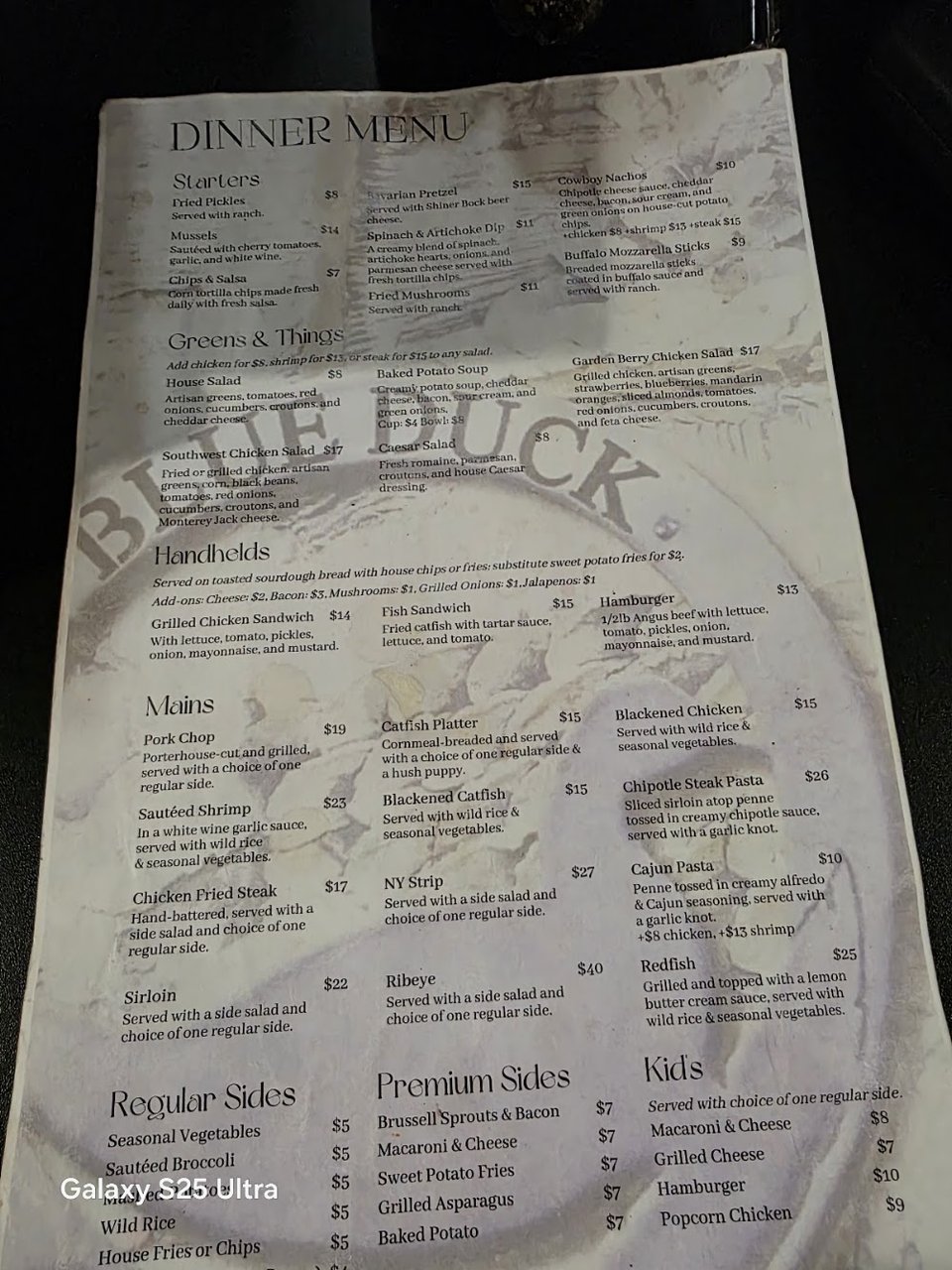 Printed menu showing starters, mains, and sides.
